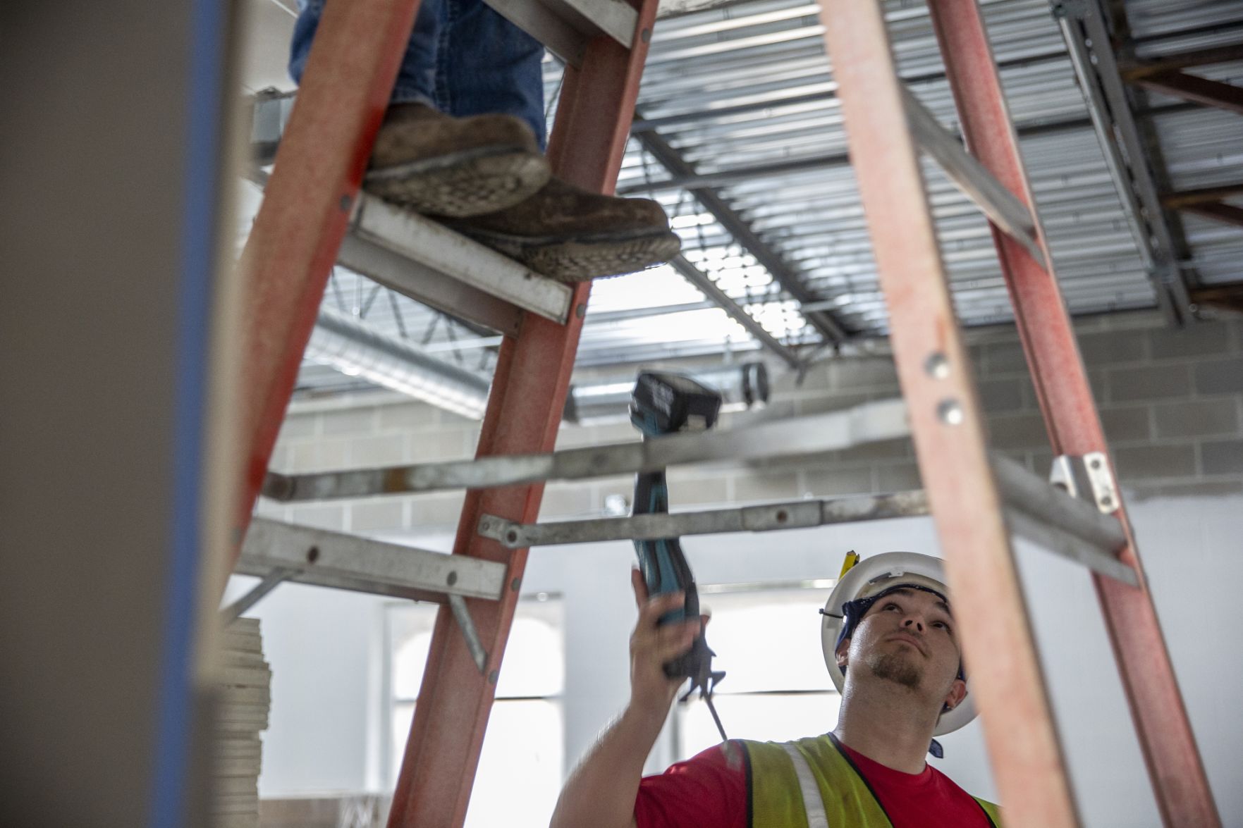 Electrical apprentices work on school expansion